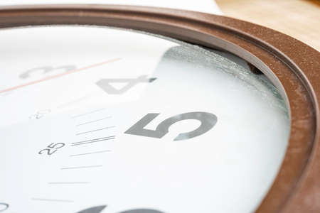 A close-up or macro shot of a broken, dirty and dusty old clock face.