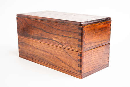 A generic studio product shot of a traditionally crafted Japanese wood bento box on a plain white background.の写真素材