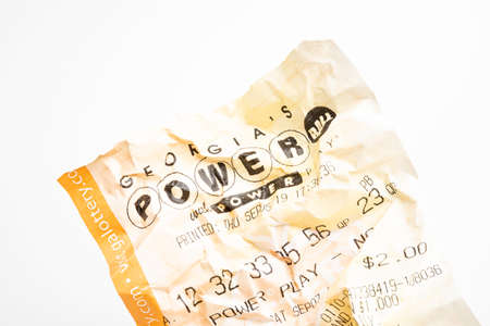 Vidalia, Georgia / USA - September 9, 2019: A close-up studio shot of the crumpled Georgia Powerball yellow lottery printout ticket.のeditorial素材