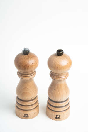 Vidalia, Georgia / USA - May 5, 2020: A medium size iconic Paris model of the Peugeot pepper and salt mill set in natural wood with metal jewel knob.のeditorial素材