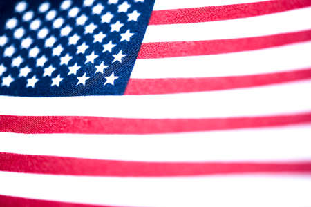 A macro shot with selective focus of a small handheld American flag on coarse fabric.の写真素材