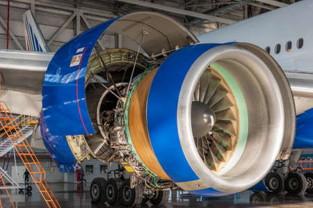 Jet engine open and ready for maintenance inside hangarの写真素材