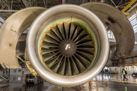 Jet engine open and ready for maintenance inside hangarの写真素材