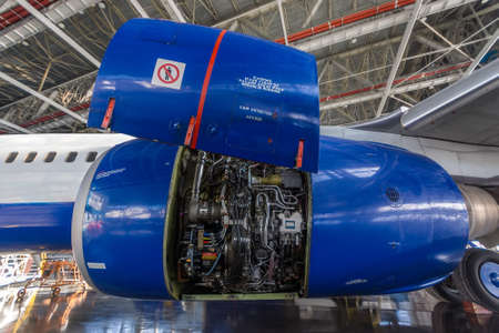 Jet engine open and ready for maintenance inside hangarの写真素材