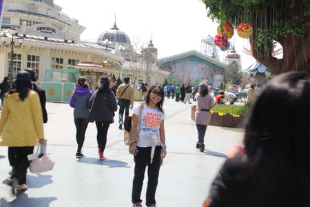 EVERLAND, YONGIN, KOREA - APRIL 06 : The unidentified group of tourists are queuing and be happy at the entrance way on april  06, 2011 at Everland, Yongin, Korea.のeditorial素材