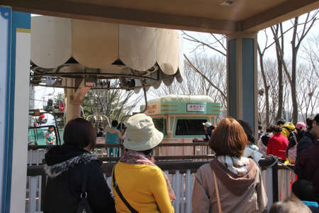 EVERLAND, YONGIN, KOREA - APRIL 06 : The unidentified group of tourists are queuing and be happy at the entrance way on april  06, 2011 at Everland, Yongin, Korea.のeditorial素材