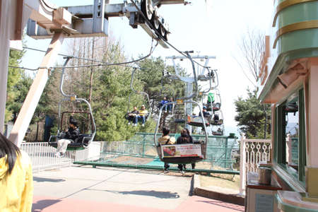 EVERLAND, YONGIN, KOREA - APRIL 06 : The unidentified tourists are travelling and enjoy Cable car is sitting   on april 06, 2011 at Everland, Yongin, Korea.のeditorial素材