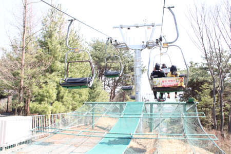 EVERLAND, YONGIN, KOREA - APRIL 06 : The unidentified tourists are travelling and enjoy Cable car is sitting   on april 06, 2011 at Everland, Yongin, Korea.のeditorial素材