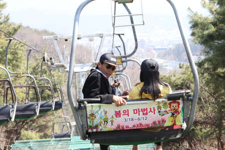 EVERLAND, YONGIN, KOREA - APRIL 06 : The unidentified tourists are travelling and enjoy Cable car is sitting   on april 06, 2011 at Everland, Yongin, Korea.のeditorial素材