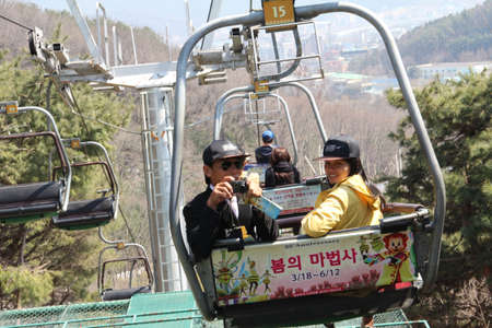 EVERLAND, YONGIN, KOREA - APRIL 06 : The unidentified tourists are travelling and enjoy Cable car is sitting   on april 06, 2011 at Everland, Yongin, Korea.のeditorial素材
