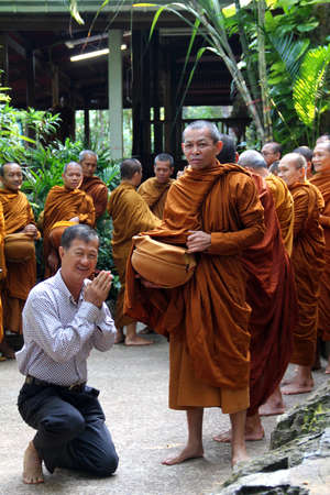 Sakon Nakhon,Thailand - October 30,2011 : Buddhist monks walk collecting alms in the morning on Kathin tradition.  on october 30, 2011 in sakon nakhon, Thailand.のeditorial素材