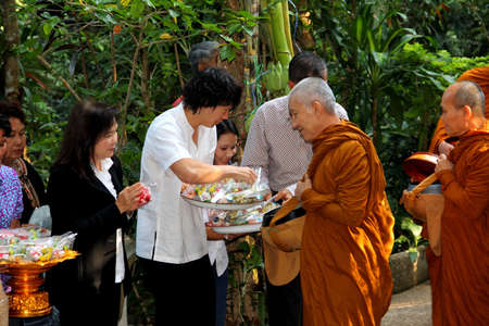 Sakon Nakhon,Thailand - October 30,2011 : Buddhist monks walk collecting alms in the morning on Kathin tradition.  on october 30, 2011 in sakon nakhon, Thailand.のeditorial素材
