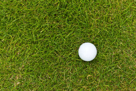 golf ball on sports golf course and hole の写真素材