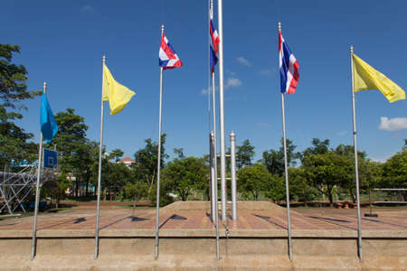 flag flying in a stiff breeze against a clear blue sky.の写真素材