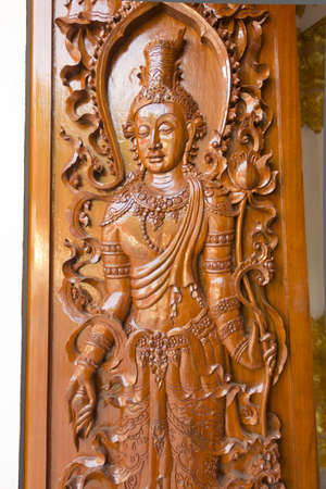 art buddha on the wood door in templeの写真素材