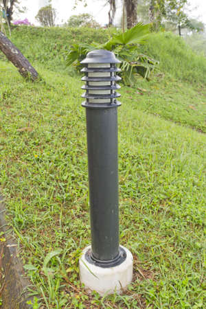 small lantern in a garden on the groundの写真素材