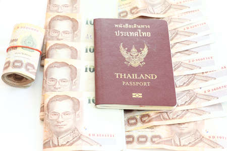 Thailand passport and Thai money on white background の写真素材