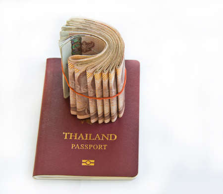 Thailand passport and Thai money on white background