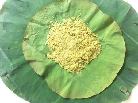 pounded unripe rice with green lotus leaf backgroundの写真素材