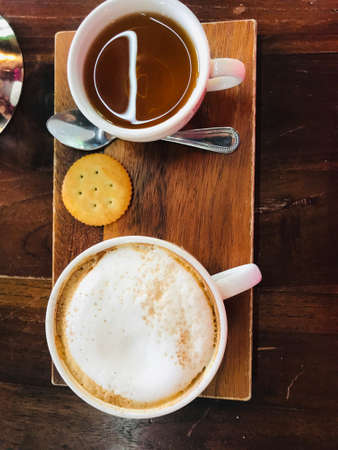 Close-up of coffee cup and tea cup on a table in cafeの写真素材