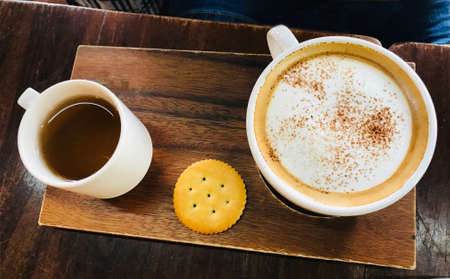 Close-up of coffee cup and tea cup on a table in cafeの写真素材
