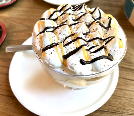 Whipped cream and chocolate on wooden table.の写真素材