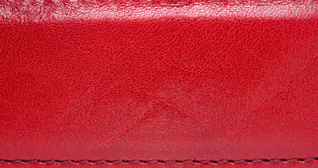 Red leather belt with seam, abstract backgroundの写真素材