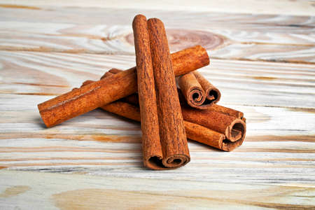 Cinnamon isolated on wooden background
