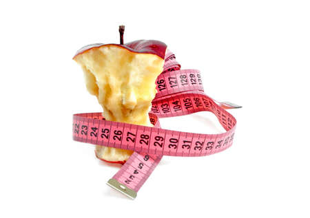 Diet concept - apple core and measuring tapeの写真素材