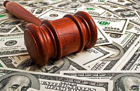Wooden gavel and American dollars