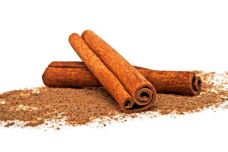 Cinnamon sticks and powder on white backgroundの写真素材