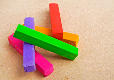 Colorful chalk pastels on color paper background