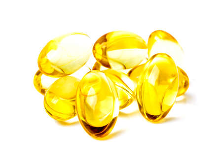 Cod liver oil omega 3 gel capsules isolated on white backgroundの写真素材