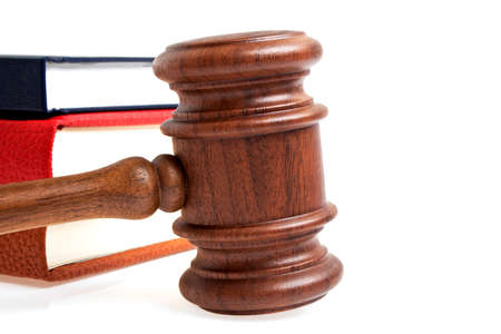Wooden gavel and books on a white backgroundの写真素材