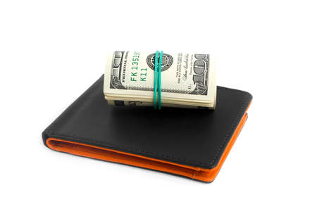 Black leather wallet and dollars on white background