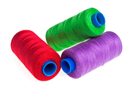 Colorful bobbin thread isolated on white backgroundの写真素材