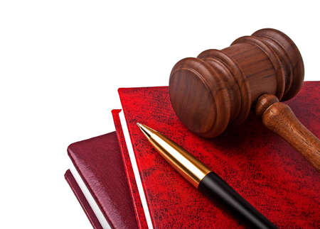 Wooden mallet, book and pen on a white background