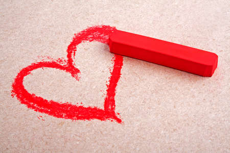 Red chalk pastels on colored paper backgroundの写真素材