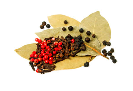 Bay leaves, carnation and pepper on a white backgroundの写真素材