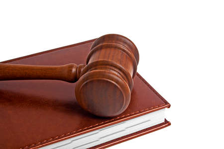 Wooden mallet and book on a white background