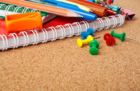 School supplies on a cork boardの写真素材