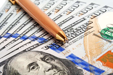 Business concept - money and penの写真素材