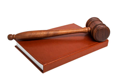 Wooden mallet and book on a white background