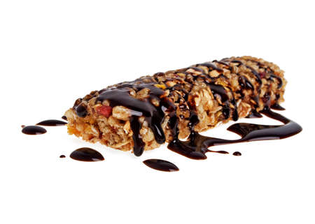 Healthy cereal bar with chocolate on a white backgroundの写真素材