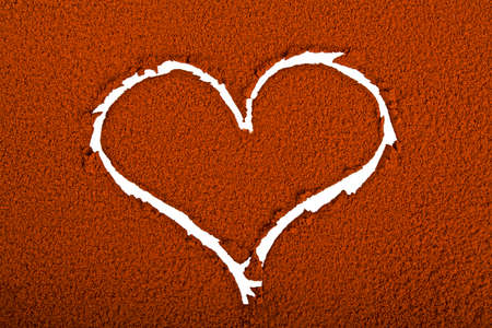 Heart on a background of cocoa powderの写真素材
