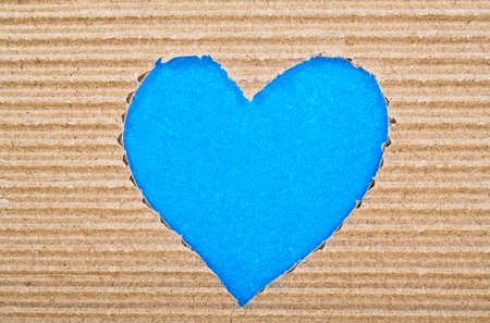 Blue heart cut from corrugated cardboardの写真素材