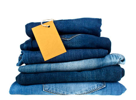 Lot of different blue jeans and brown label on a white backgroundの写真素材