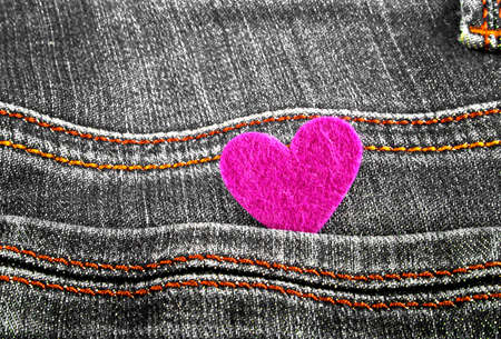 Violet heart in jeans pocketの写真素材