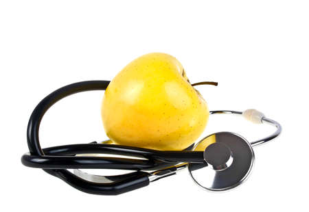 Concept for diet and healthcare - yellow apple and stethoscope on a white backgroundの写真素材