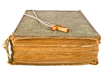 Closeup of simple wooden Christian cross on old book